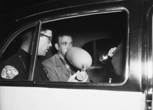 Image of a man taking a privative breath alcohol test.